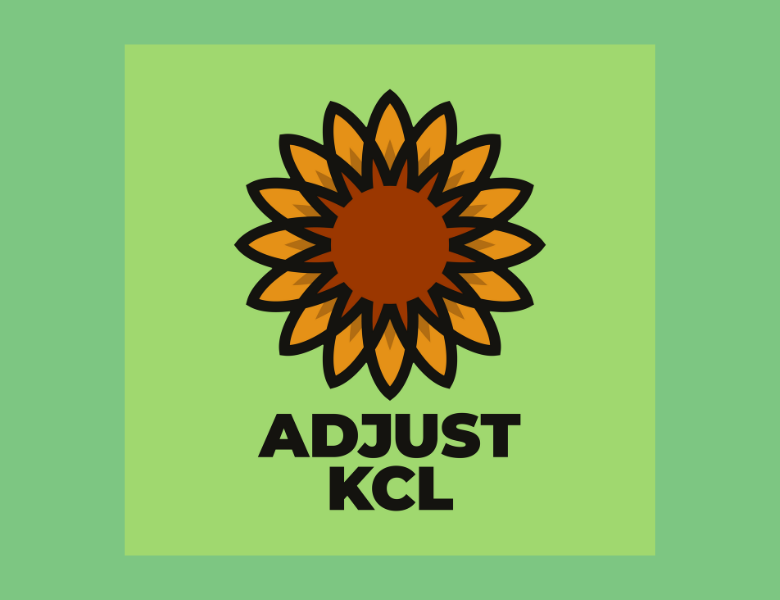 A group of students huddle round a table with paper and pens, planning a campaign.