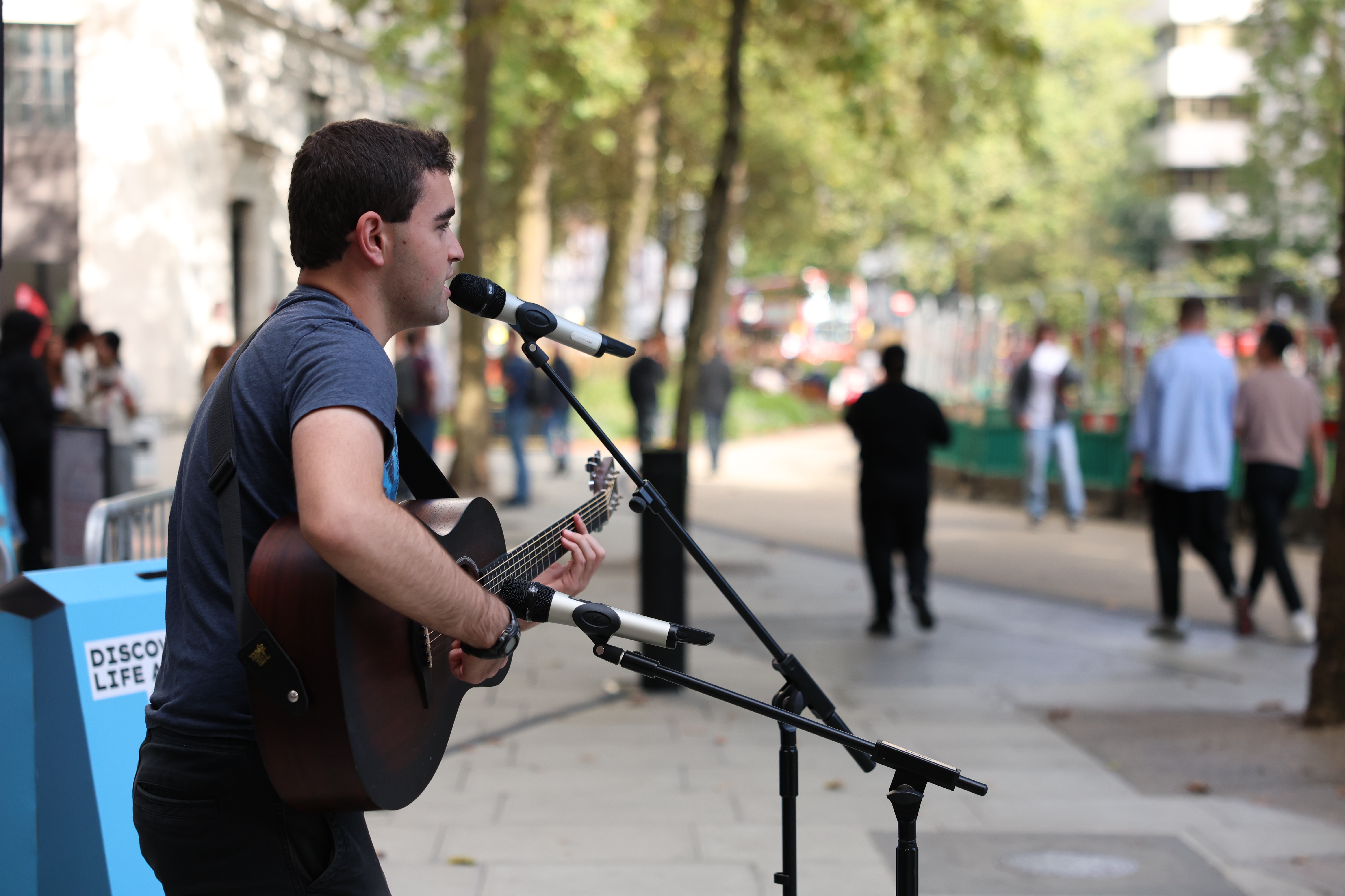 Student playing guitar at welcome event