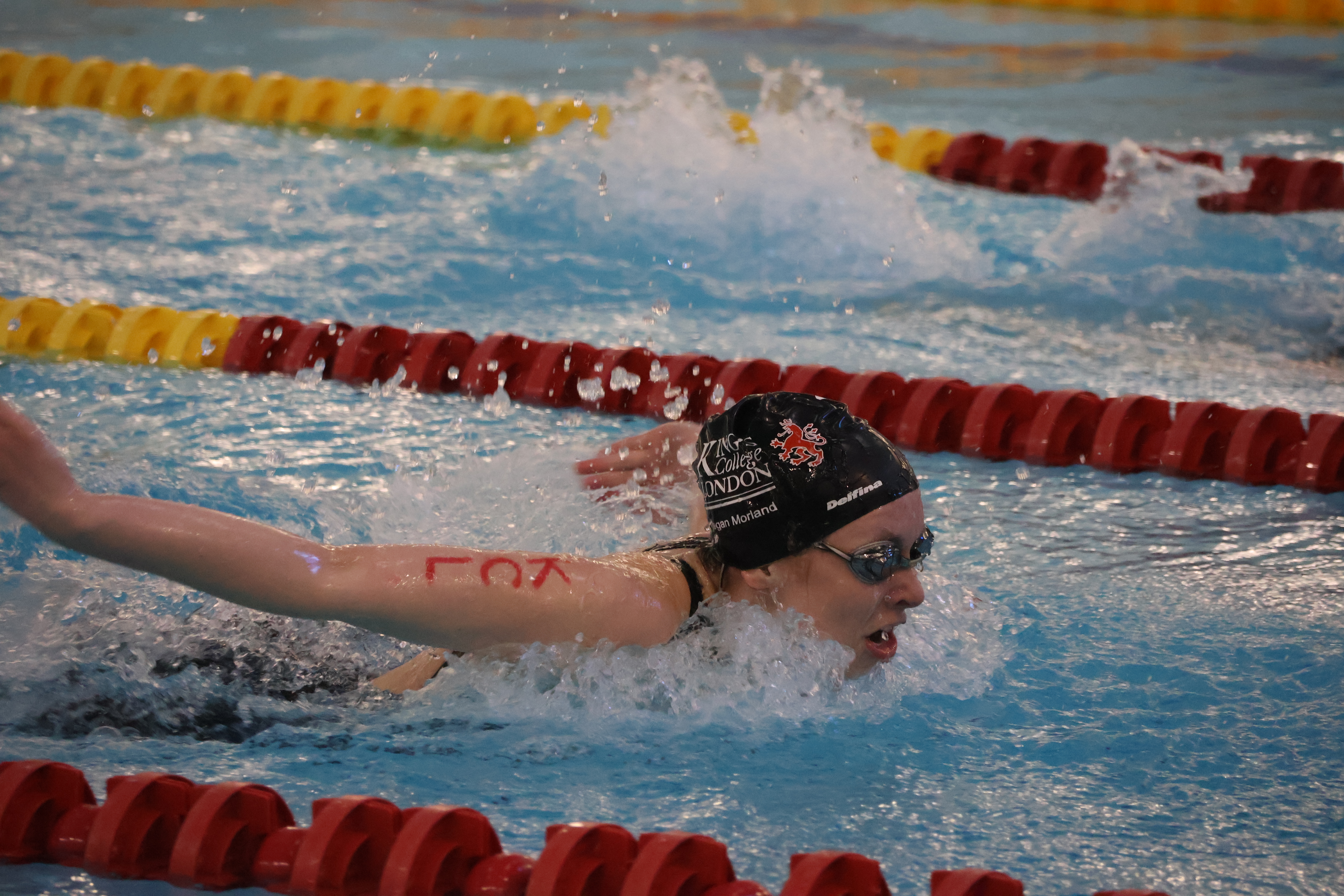 Swimmer zoomed in competing at varsity.