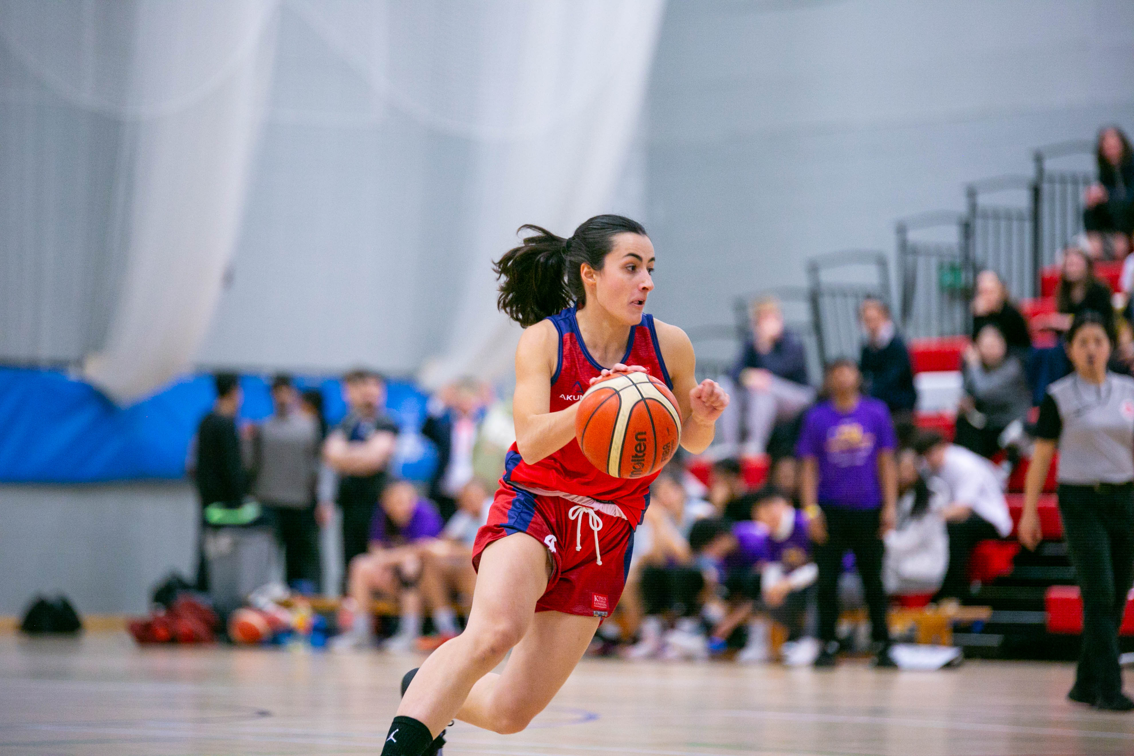 KCL Women's Basketball player dribbling during varsity