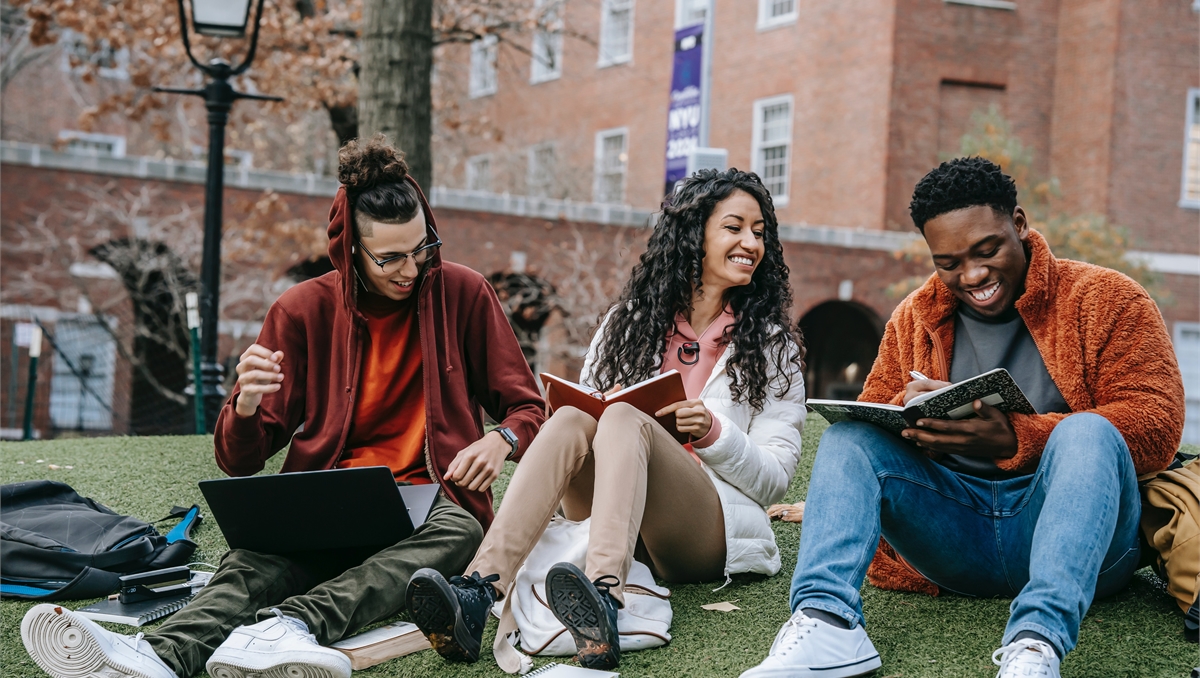 Photo by Keira Burton: https://www.pexels.com/photo/cheerful-multiethnic-students-with-books-sitting-near-university-6146978/
