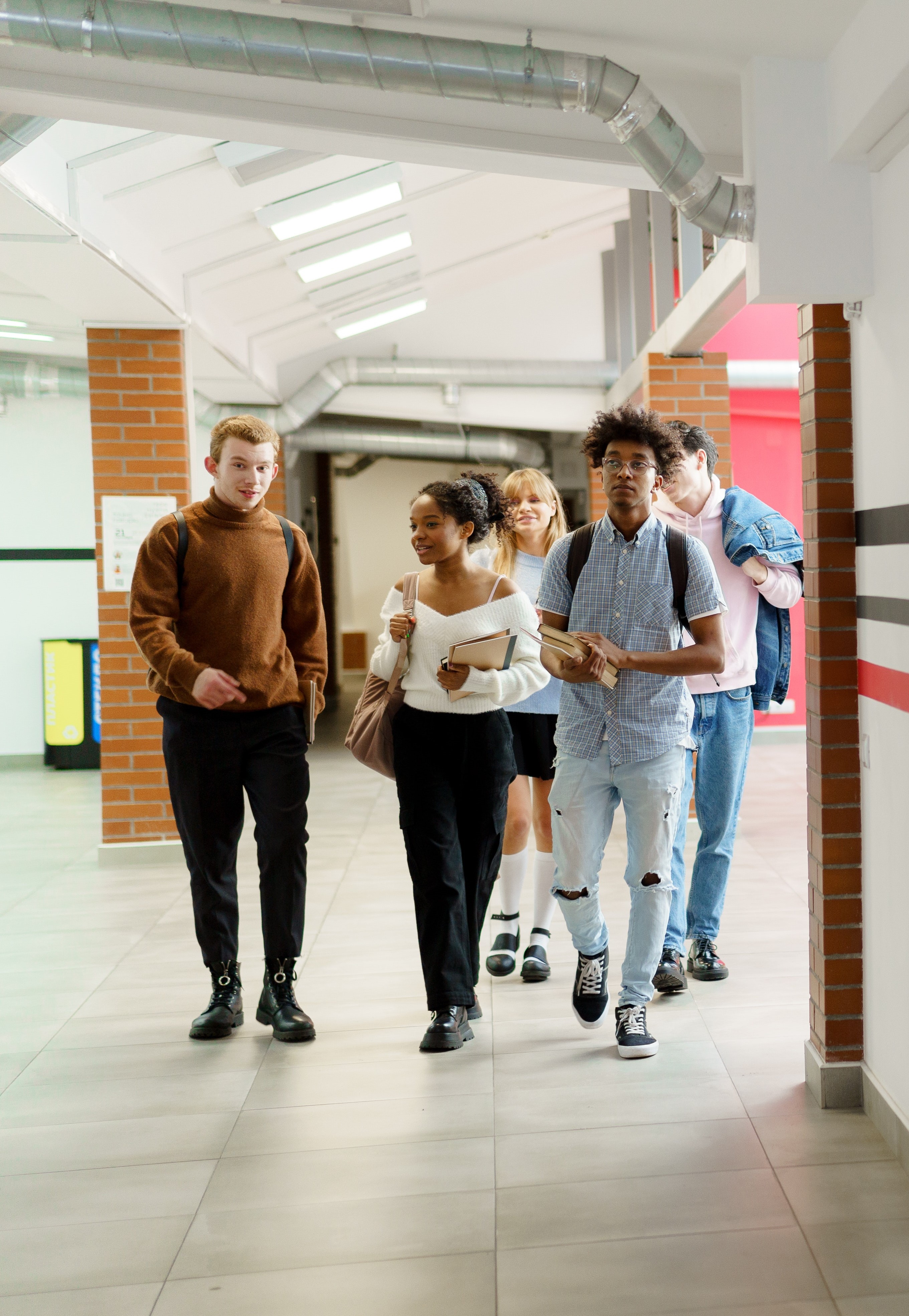 group of students walking through a corridor